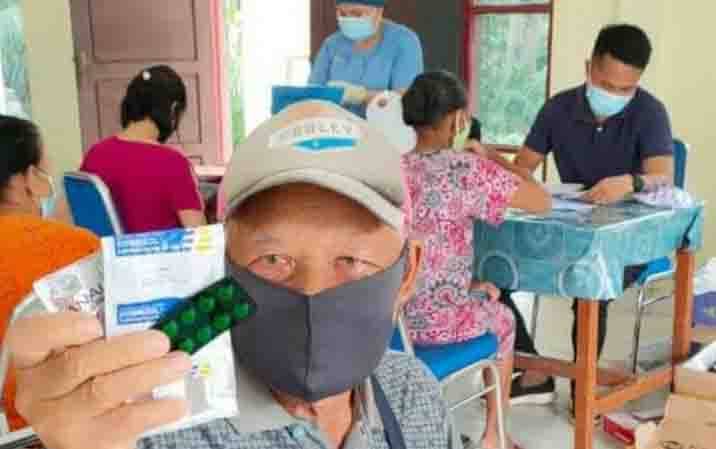 Seorang lansia dari Kelurahan Tumbang Talaken menunjukkan obat-obatan yang diterima saat memeriksa kesehatan di Posyandu Lansia.