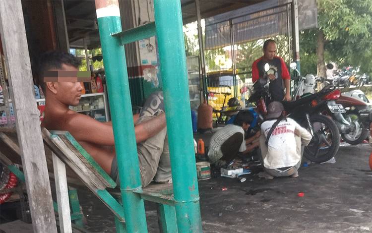 Pria diduga mengalami gangguan jiwa (tidak kenakan baju) saat duduk santai di bengkel kendaraan Jalan Seth Adji, Kota Palangka Raya.