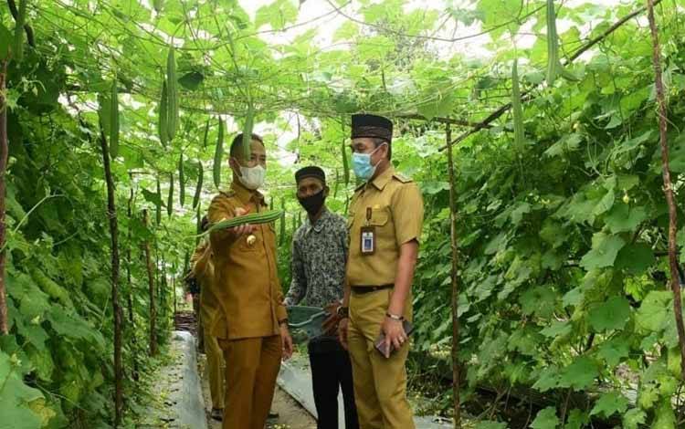 Wali Kota Palangka Raya, Fairid Naparin menunjukan hasil produksi perkebunan warga saat Musrenbang