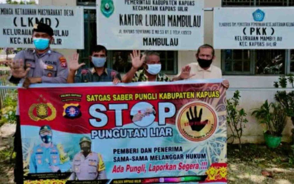 Personel Polsek Kapuas Hilir saat mengajak masyarakat tolak praktik pungli, di kantor Kelurahan Mambulau pada Rabu 10 Maret 2021.