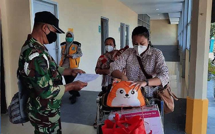 Petugas melakukan pengecekan surat keterangan bebas covid-19 melalui pemeriksaan RT-PCR pada penumpang yang tiba di Bandara Iskandar Pangkalan Bun.