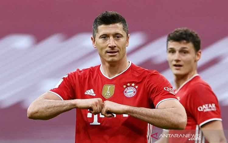 Penyerang Bayern Muenchen Robert Lewandowski merayakan keberhasilannya mencetak trigol ke gawang Borussia Moenchengladbach dalam lanjutan Liga Jerman di Stadion Allianz Arena, Muenchen, Jerman, Sabtu (8/5/2021)