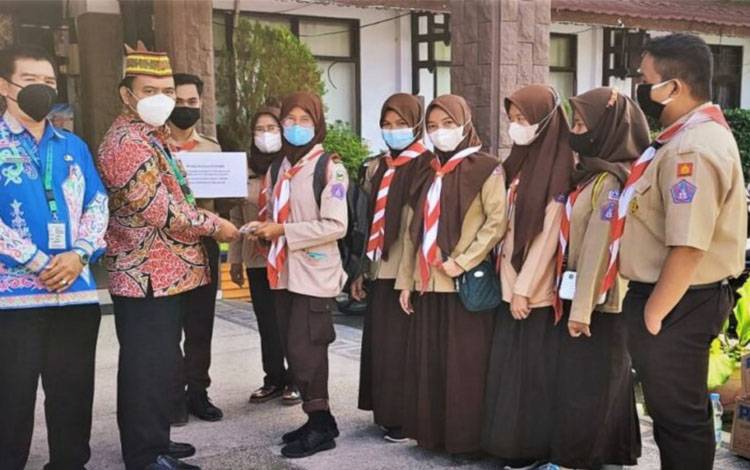 Kepala Disdik Kapuas, Suwarno Muriyat bersama anggota Pramuka Kapuas dalam penggalangan dana
