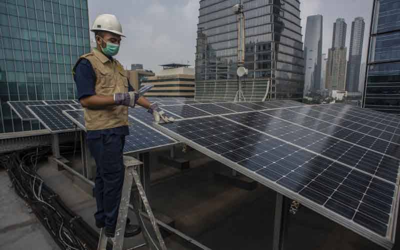 Petugas merawat panel surya yang terpasang di atap Gedung Direktorat Jenderal (Dirjen) Ketenagalistrikan Kementerian Energi dan Sumber Daya Mineral (EDSM), Jakarta, Senin (24/5/2021). (foto : ANTARA FOTO/Aprillio Akbar/hp)