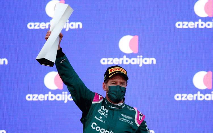 Pebalap tim Aston Martin Sebastian Vettel melakukan selebrasi setelah finis runner-up di Grand Prix Azerbaijan, Sirkuit Baku. (6/6/2021) (ANTARA/REUTERS/Anton Vaganov)