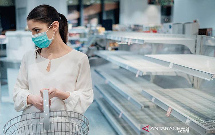 Ilustrasi seorang perempuan mengenakan masker, sedang berbelanja di supermarket namun seuruh barang sudah habis terjual akibat panic buying. (Shutterstock)