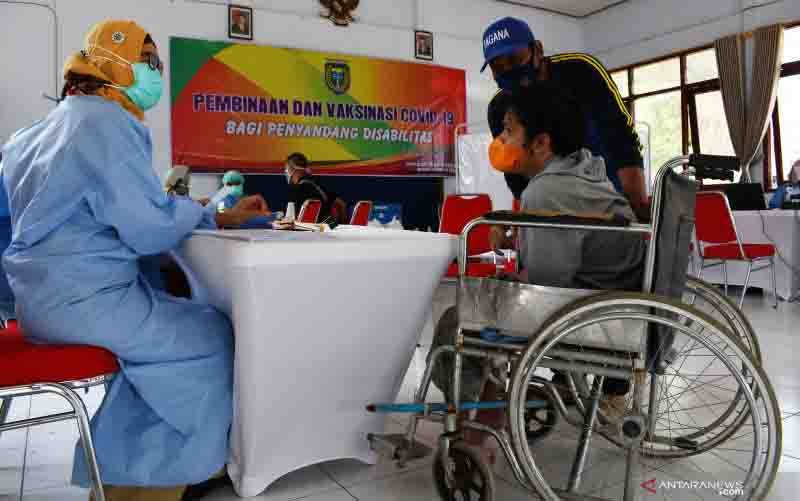 Penyandang disabilitas antre untuk vaksinasi COVID-19 di Aula Shelter Dinas Sosial Pemberdayaan Perempuan dan Perlindungan Anak Kota Madiun, Jawa Timur, Senin (9/8/2021). (foto : ANTARA FOTO/Siswowidodo)
