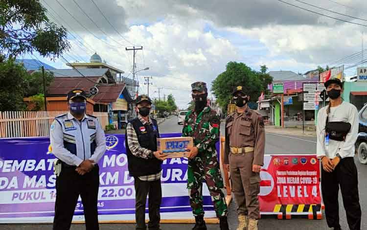Plt Camat Selat, Yaya Setiabudi saat menyambangi petugas pos penyekatan simpang tiga Jalan Tambun Bungai - Patih Rumbih, Minggu sore, 15 Agustus 2021.