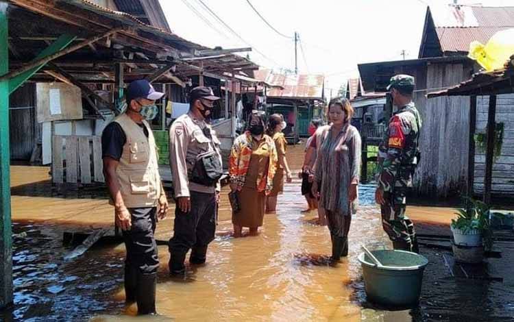 Pihak Kelurahan Langkai bersama petugas gabungan saat meninjau permukiman warga Flamboyan bawah yang terdampak banjir.
