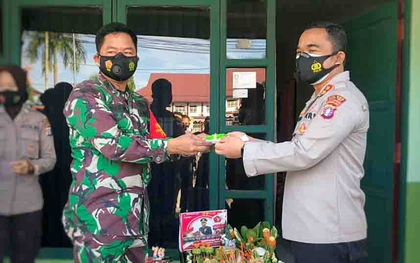 Pabung Kodim 1012 Buntok, Mayor Inf Tubagus Abdul Halim menyerahkan potongan tumpeng kepada Kapolres Barito Timur, AKBP Affandi Eka Putra saat peringatan HUT ke 76 TNI, Selasa, 5 Oktober 2021.