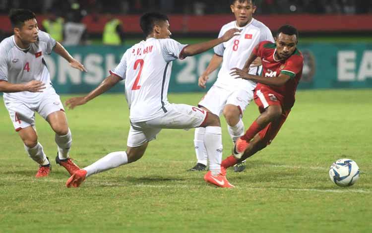 Pesepak bola Indonesia U-19 Todd Rivaldo Alberth Ferre (kanan) berusaha melewati sejumlah pesepak bola Vietnam U-19 dalam laga penyisihan grup A Piala AFF U19 di Gelora Delta Sidoarjo, Sidoarjo, Jawa Timur, Sabtu (7/7). Indonesia unggul atas Vietnam dengan skor 1-0 dan memastikan Indonesia lolos kebabak semi final. 