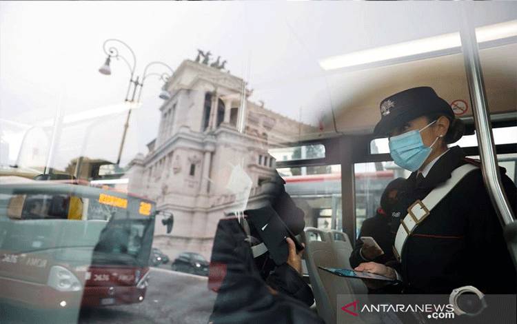 Arsip - Penumpang menunjukkan Green Pass, kartu kesehatan COVID-19, saat hendak menaiki sebuah bus setelah pemerintah memberlakukan akses terbatas bagi yang belum divaksin di ruangan tertutup di Roma, Italia, 6 Desember 2021. Gambar diambil dari luar bus. (ANTARA/Reuters/Yara Nardi/aww/sa)