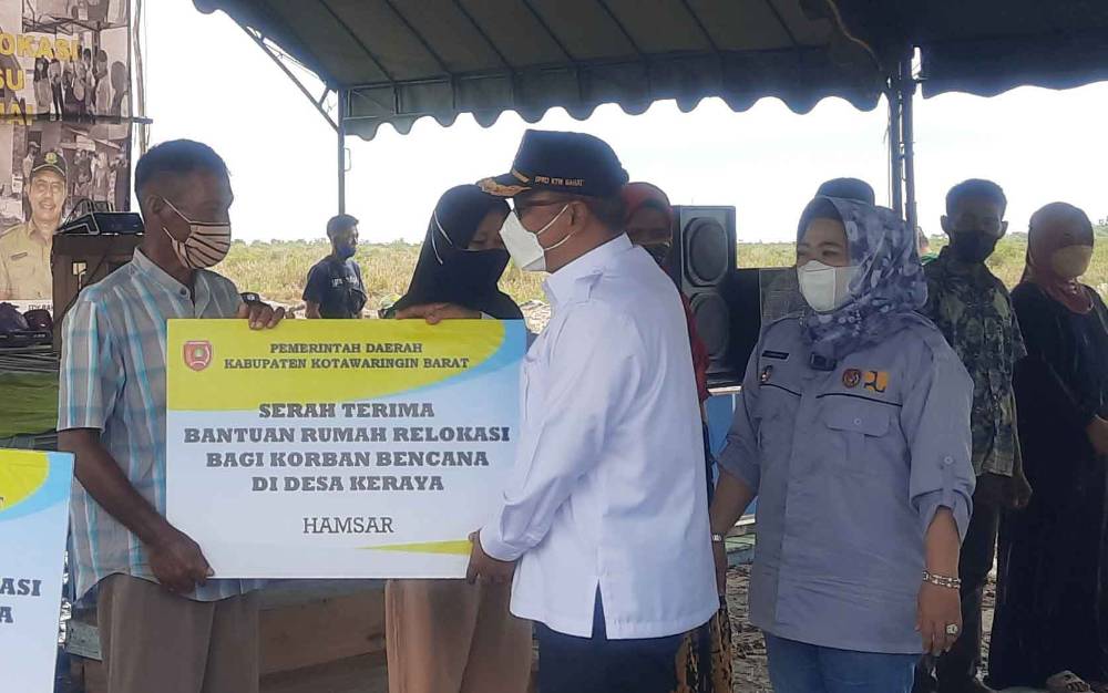 Ketua DPRD Kobar, Rusdi Gozali saat menyerahkan simbolis bantuan rumah kepada warga terdampak bencana abrasi di Desa Keraya, Rabu, 12 Januari 2022.