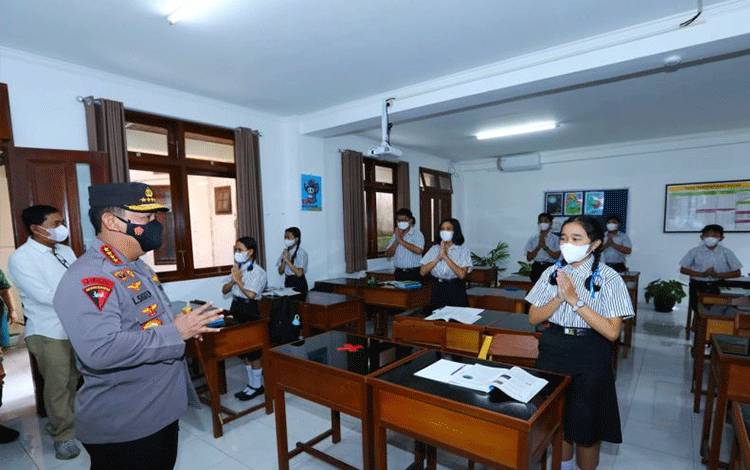 Kapolri Jenderal Pol. Listyo Sigit Prabowo saat meninjau penerapan protokol kesehatan (prokes) dan berdialog dengan para pelajar dalam pembelajaran tatap muka di SMP Kristen 1 Harapan, Denpasar, Bali, Sabtu (15/1/2022). ANTARA/HO-Humas Polri
