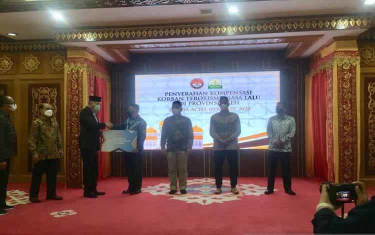 Gubernur Aceh, Nova Iriansyah bersama Wakil Ketua LPSK menyerahkan kompensasi kepada korban terorisme masa lalu di Provinsi Aceh di Pendopo Gubernur Aceh, Banda Aceh