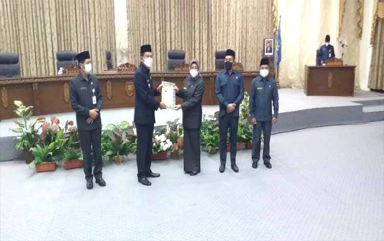 Bupati Barito Utara, Nadalsyah didampingi Sekda Muhlis menyerahkan LKPJ 2021 kepada Ketua DPRD Mery Rukaini, Kamis 31 Maret 2022
