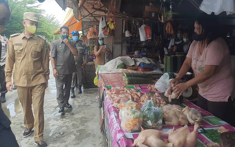 Bupati Gunung Mas Jaya S Monong saat turun langsung untuk mengecek ketersediaan dan harga pangan di pasaran.