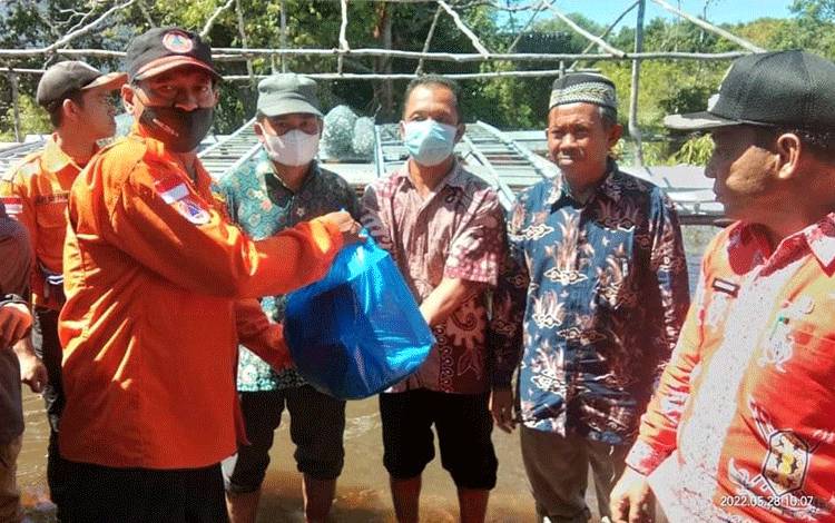 Kepala Pelaksana BPBD Barsel, Alip Suraya menyerahkan bantuan sembako non beras kepada korban banjir.