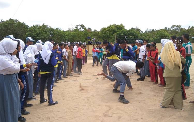 Pelajar SMKN 1 Sukamara saat melakukan lomba Tarik tambang dihalaman sekolah yang disaksikan oleh dewan guru dan pelajar lainnya. (FOTO:NORHASANAH)