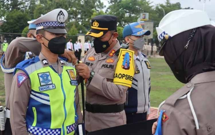 Kapolres Kapuas AKBP Qori Wicaksono menyematkan tanda personel Operasi Zebra Telabang pada apel gelar pasukan, Senin, 3 Oktober 2022. (FOTO: POLRES KAPUAS)