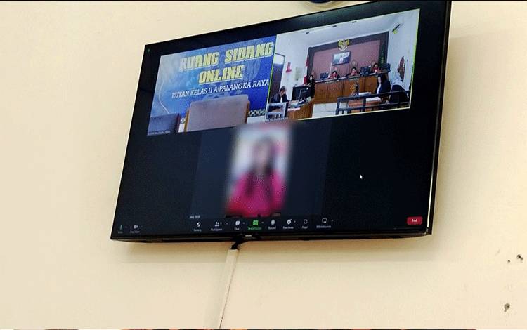 Terdakwa (bawah) saat menjalani sidang virtual di Pengadilan Negeri Palangka Raya beberapa waktu lalu (Foto: Apriando)