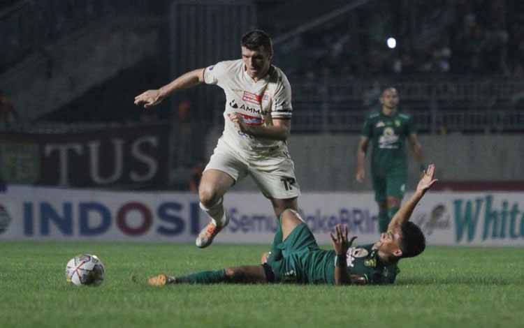 Pemain Persebaya Ahmad Nufiandani (kanan) terjatuh saat berhadapan dengan pemain Persija Ondrej Kudela (kiri) saat pertandingan Liga 1 Indonesia musim 2022/2023 di Stadion Gelora Joko Samudro, Gresik, Rabu (5/4/2023). (ANTARA/Moch Asim)