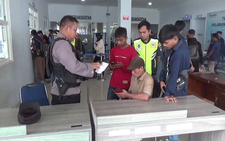 Petugas melakukan pemeriksaan tiket milik korban penipuan tiket palsu di pintu masuk Pelabuhan Panglima Utar Kumai. (FOTO : ISTIMEWA)