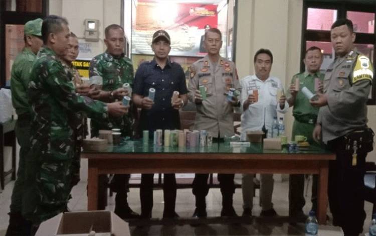 Kepala Polsek Batang AKP Achmad Almunasifi bersama TNI dan ormas memamerkan ratusan petasan dan botol minuman yang disita pada operasi gabungan, Jumat malam (21/4/2024). (ANTARA/HO-Humas Polres Batang)