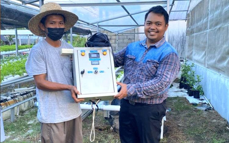 Penyerahan secara simbolis satu set sistem PLTS oleh Ketua Tim Pelaksana, Yunus Pebriyanto kepada pemilik UMKM Maestro Borneo Hidroponik Farm.(FOTO: Dokumentasi Yunus untuk Borneonews)