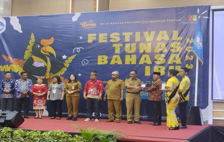 Kepala Balai Bahasa Kalteng menyerahkan penghargaan kepada Pemerintah Provinsi Kalimantan Timur dalam upaya revitalisasi bahasa daerah, Selasa, 21 November 2023. (FOTO: TESTI PRISCILLA)