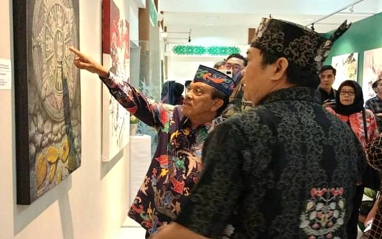 Wakil Ketua I DPRD Kalteng, Abdul Razak (menunjuk sebuah seni lukisan) saat ketika menghadiri kegiatan pameran seni rupa di Palangka Raya. (FOTO: DOK ABDUL RAZAK)