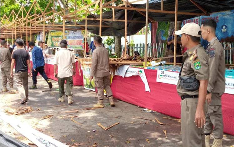 Personel Satpol PP dan Damkar Kapuas saat bantu bersihkan lapak pedagang Pasar Ramadan usai terkena angin kencang, kemarin. (FOTO: IST)