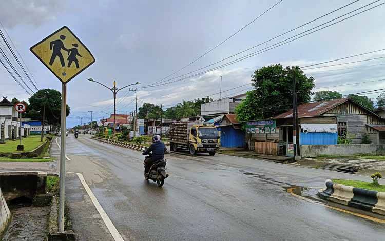 Jalan di pusat Kota Tamiang Layang Kabupaten Barito Timur yang masih basah setelah diguyur hujan deras durasi singkat, Jumat, 26 April 2024. (FOTO: BOLE MALO)