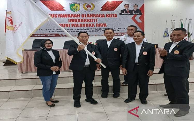 Ketua KONI Palangka Raya terpilih  Sigit Widodo menerima bendera dari Ketua KONI yang lama Karuhei TN Asang (dua dari kanan) usai Musorkot KONI setempat di Palangka Raya, (27/4/2024). ANTARA/Adi Wibowo 