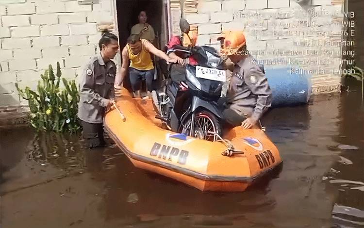 BPBD Kabupaten Kotawaringin Timur membantu warga evakuasi kendaraan di tengah banjir di Jalan Teratai IV, Sampit, Senin, 29 April 2024. (FOTO: BPBD Kotim)