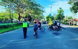 Beri Rasa Aman, Polisi Bantu Anak Sekolah Menyeberang Jalan